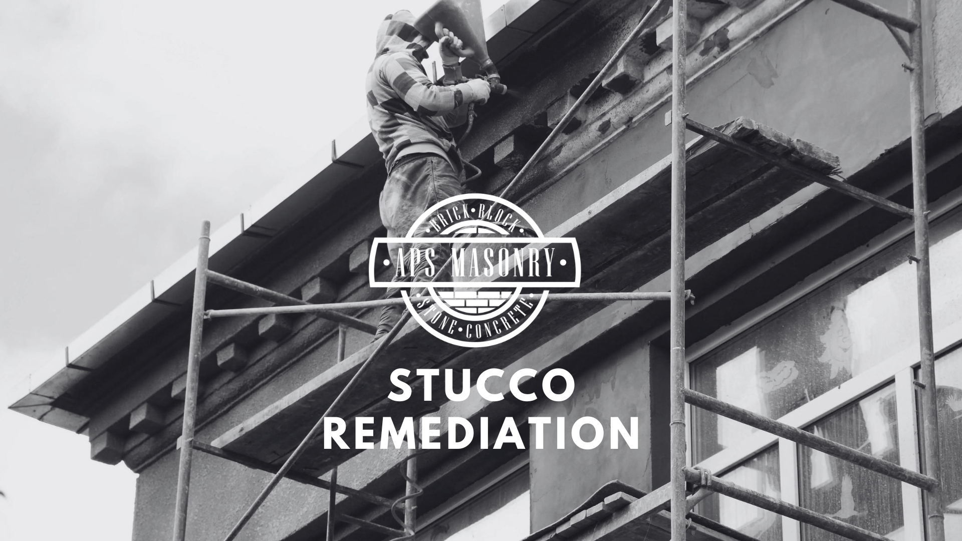 A monochrome image displaying a worker on scaffolding engaged in stucco remediation on the exterior of a building. The worker is wearing a hooded jacket and using a tool on the wall. The APS Masonry logo is superimposed in the center, and the text