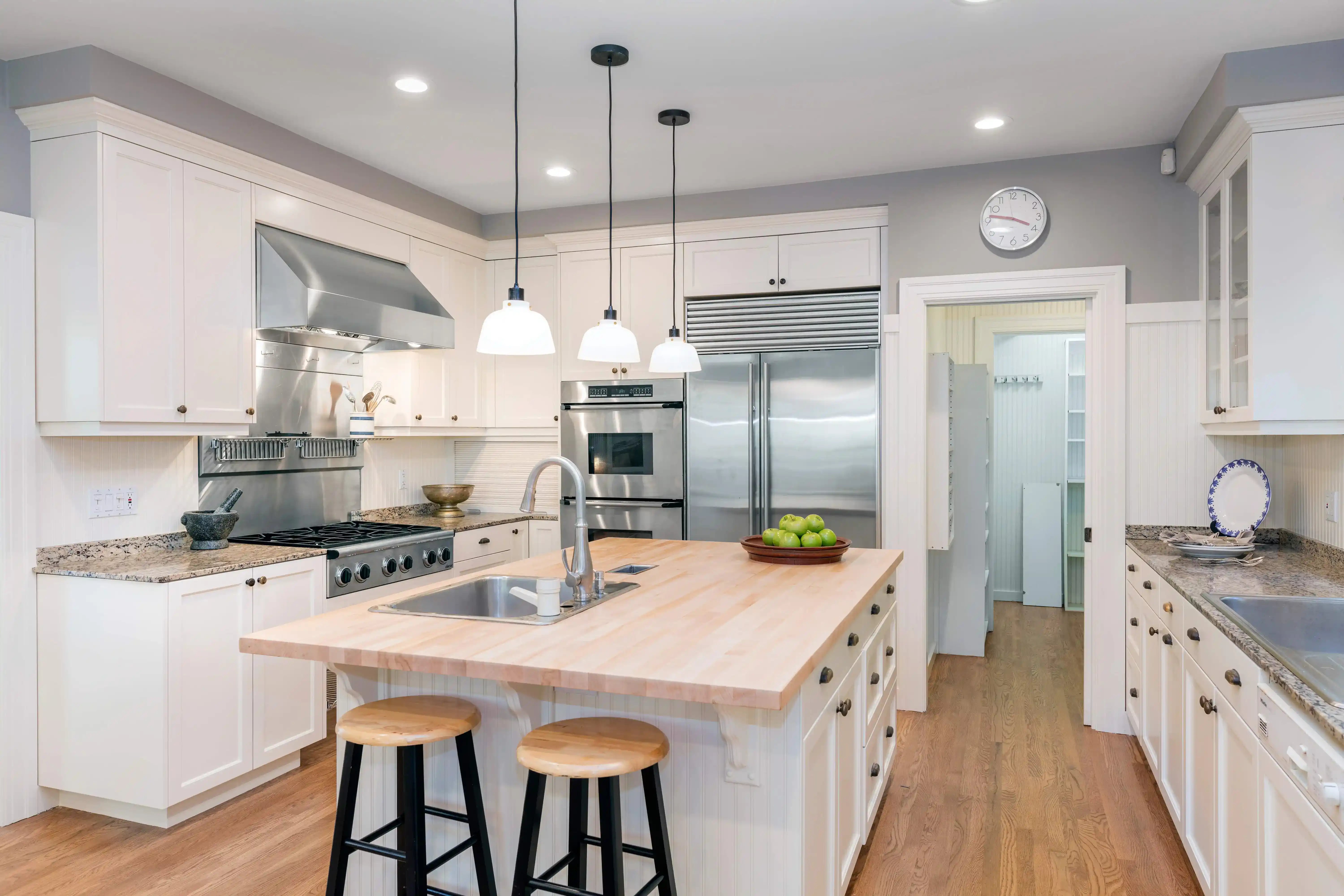 Modern kitchen with a central island, stainless steel appliances, and pendant lighting