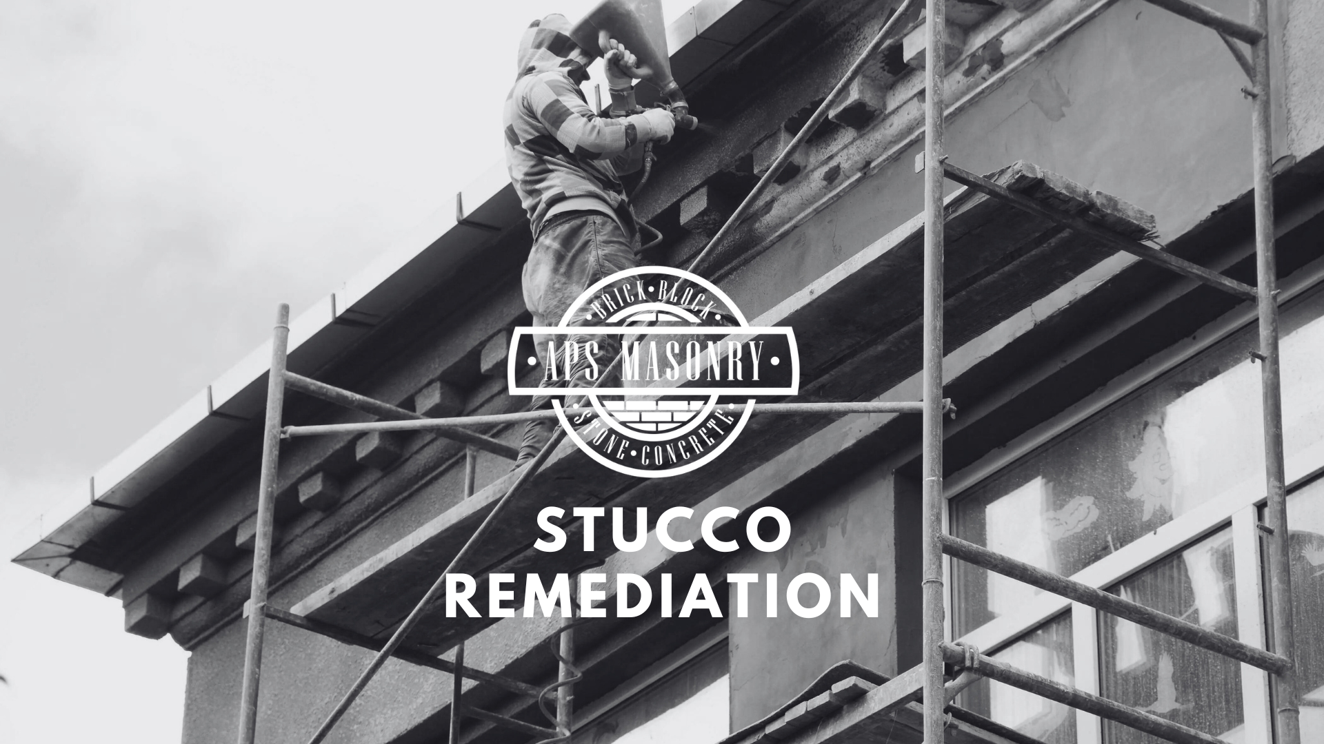 A monochrome image displaying a worker on scaffolding engaged in stucco remediation on the exterior of a building. The worker is wearing a hooded jacket and using a tool on the wall. The APS Masonry logo is superimposed in the center, and the text 