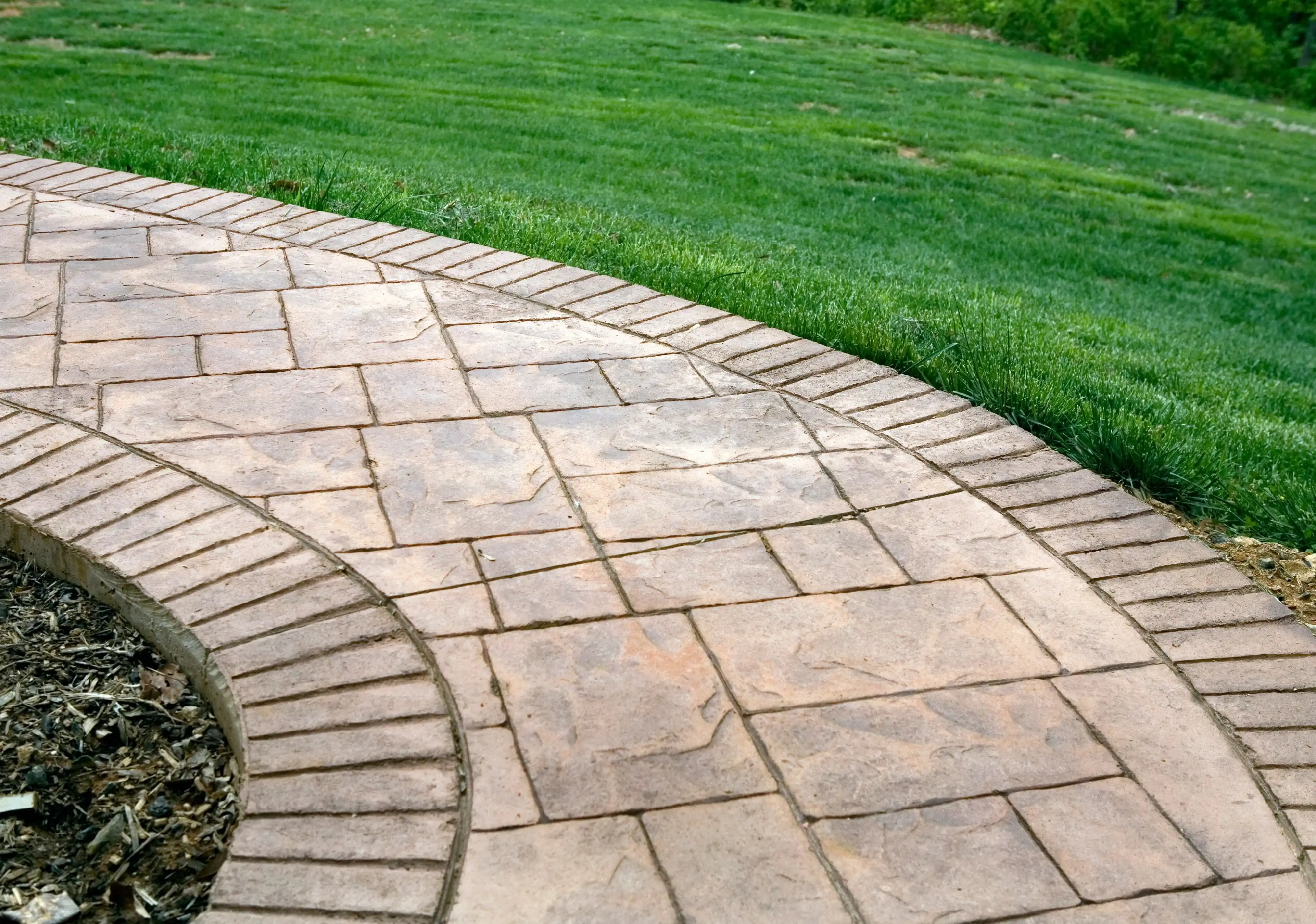 Beautiful stamped concrete walkway with brick pattern design in a Philadelphia backyard